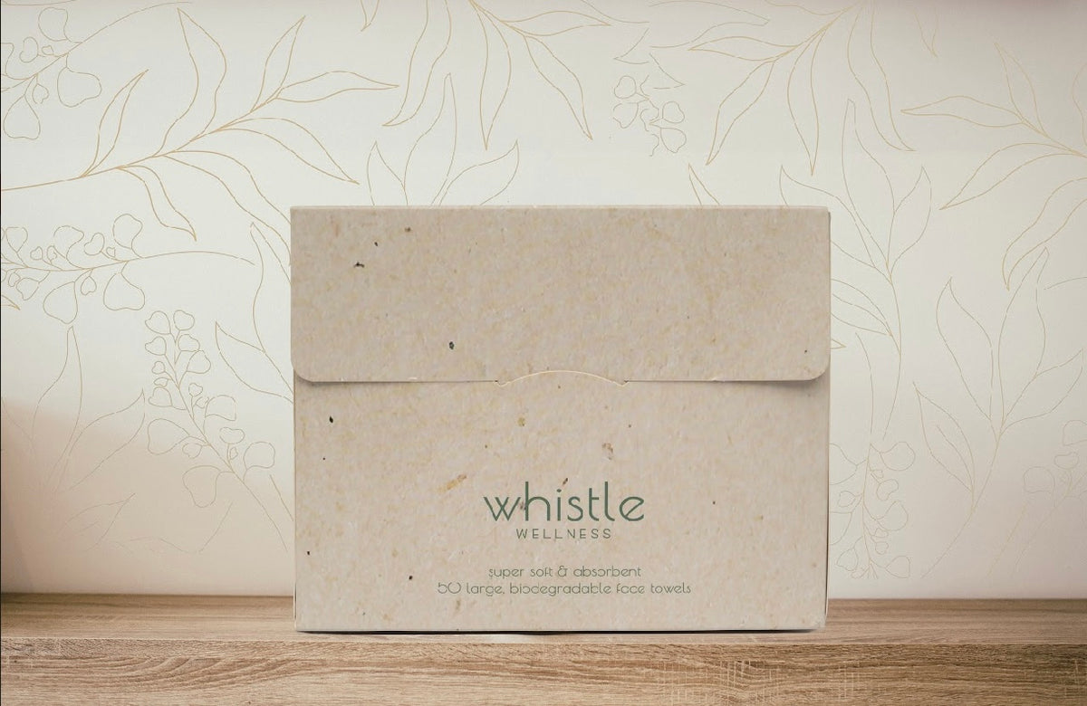 Whistle face towel box on a wooden bathroom shelf