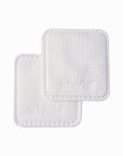 Two square Whistle cotton face pads showing textured and smooth surfaces